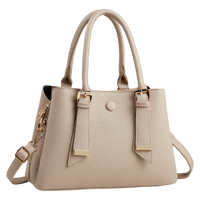 A light beige pebbled faux-leather handbag with dual top handles, a detachable shoulder strap, and gold-tone hardware, shown on a plain white background.