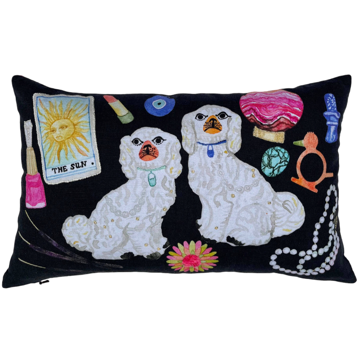 Decorative pillow with two white dogs, colorful objects, and a sun symbol on a black background.