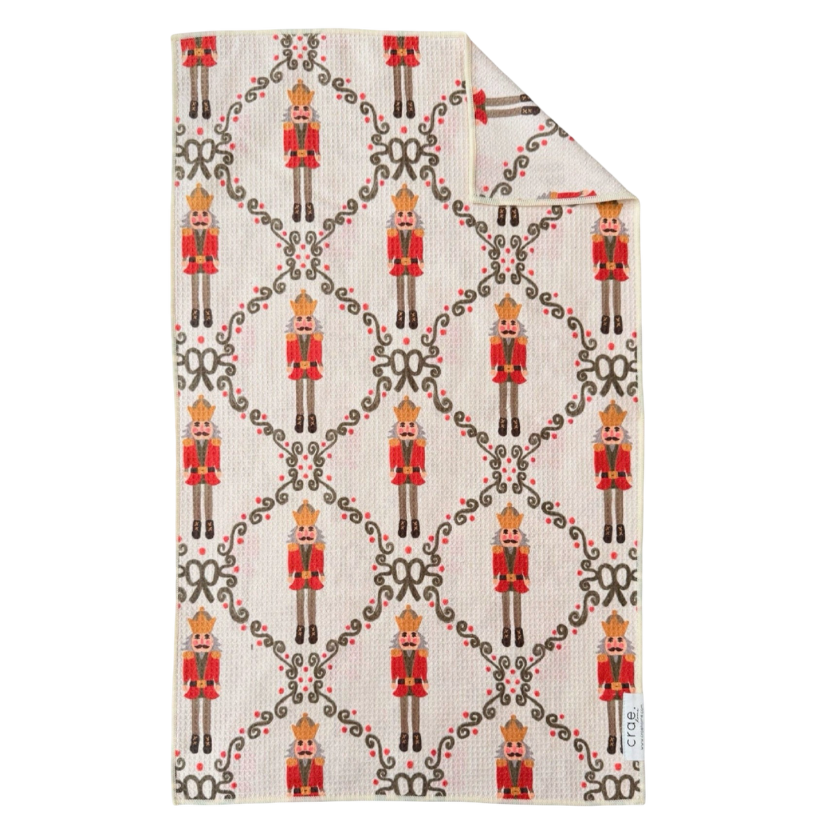 Crae.Home Capt' Nutty double-sided Christmas hand towel with traditional red nutcrackers and festive green decorative motifs on cream