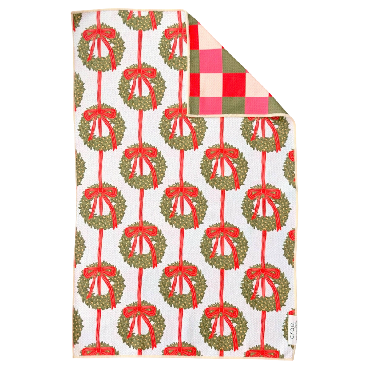 Crae.Home Wrapped in Wreaths reversible Christmas hand towel featuring green wreaths with red bows on cream and a red and pink checkered reverse