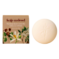 Kate McLeod Vanilla & Copaiba Body Stone solid lotion bar with botanical packaging and round white moisturizing bar.