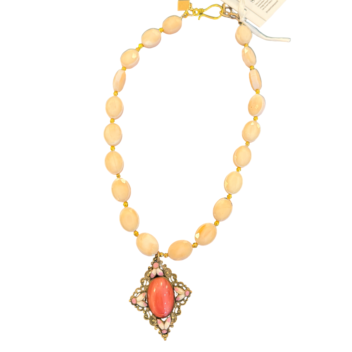 Made in the Deep South blush bead necklace with an ornate coral-tone pendant and gold-tone hook closure.