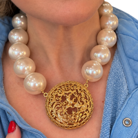 Made in the Deep South oversized faux pearl necklace with vintage gold Napier pendant worn with a light blue top
