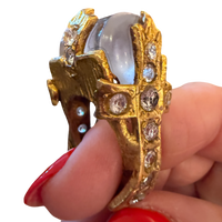 Made in the Deep South vintage ring with a gray cabochon and gold-tone cross set with clear faceted accents.