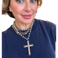 
Meredith wearing the one-of-a-kind Made in the Deep South vintage 1950s rhinestone cross necklace, showcasing its sparkling pendant and delicate beaded design styled with layered jewelry.