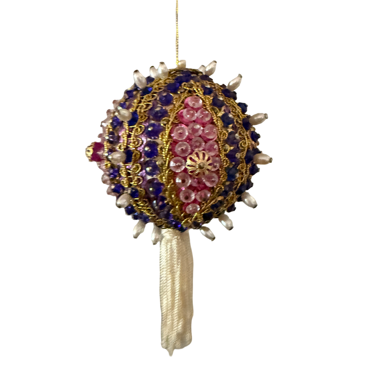 Vintage round ornament with purple beads, pink sequins, gold-tone braid, pearl-look accents, and an ivory tassel hanging from a gold cord.