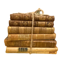 Stack of old books tied with twine on a white background