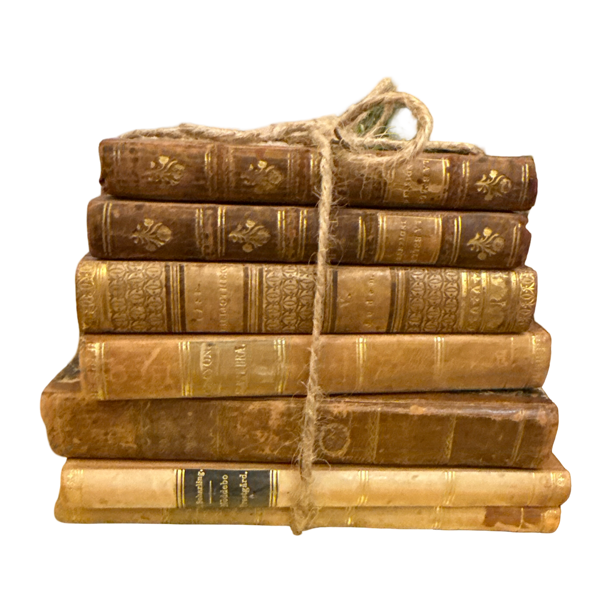 Stack of old books tied with twine on a white background