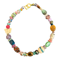 A handmade beaded necklace featuring a variety of colorful, textured glass and wooden beads, including a butterfly charm and a gold clasp, displayed on a clean white background.