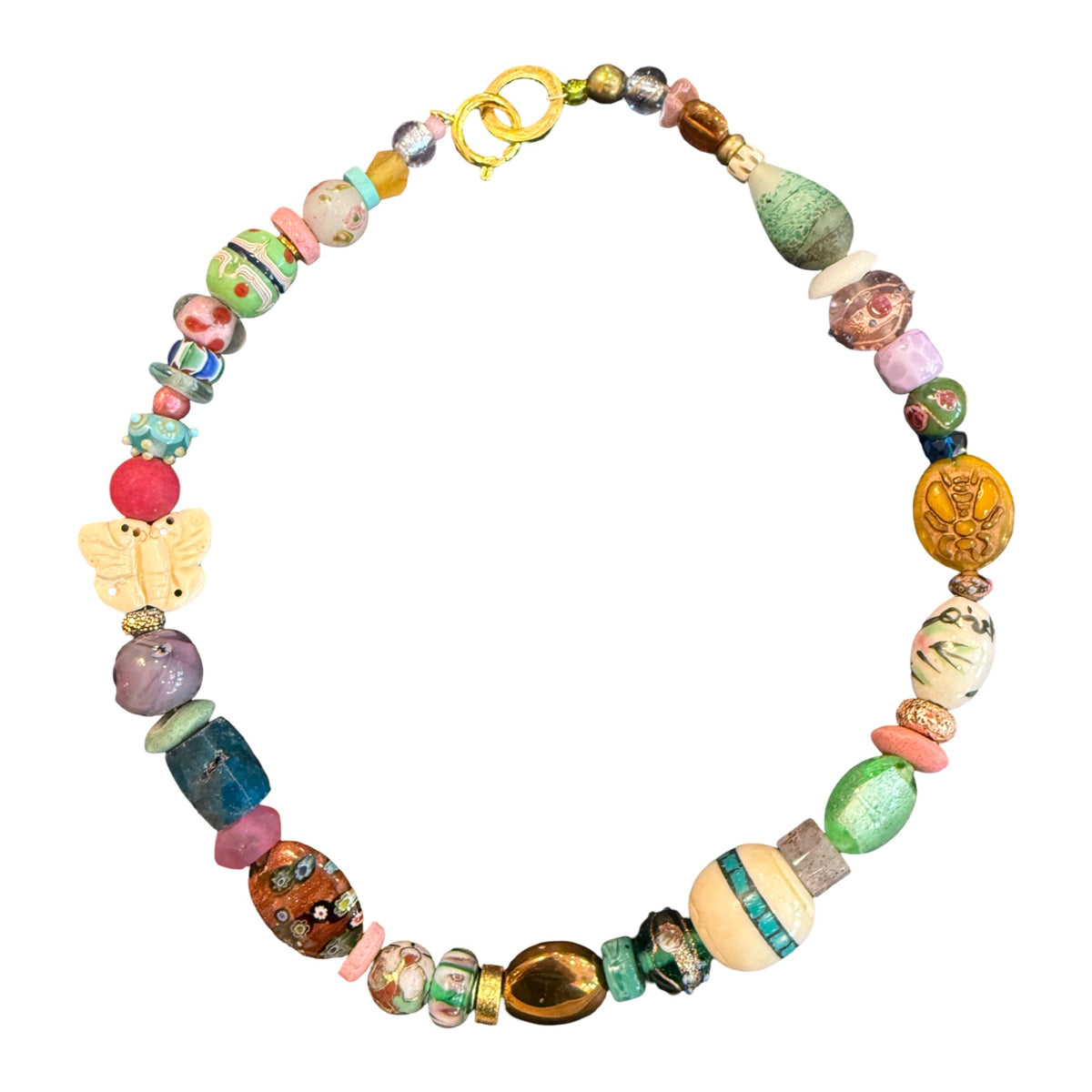 A handmade beaded necklace featuring a variety of colorful, textured glass and wooden beads, including a butterfly charm and a gold clasp, displayed on a clean white background.