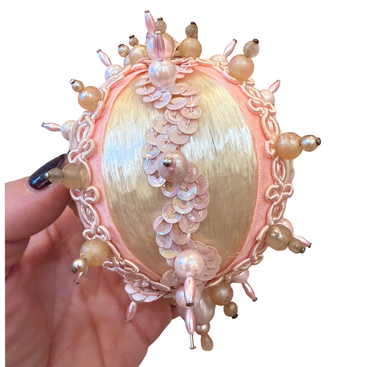 handmade vintage Christmas ornament featuring ivory satin, blush pink pearl embellishments, delicate gold trim, and dangling pink beads.