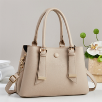 Apricot structured top handle handbag with adjustable crossbody strap and gold-tone hardware