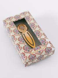Good Juju Ink Folk Heart Metal Clip Bookmark with colorful heart illustration and gold-tone finish in patterned gift packaging