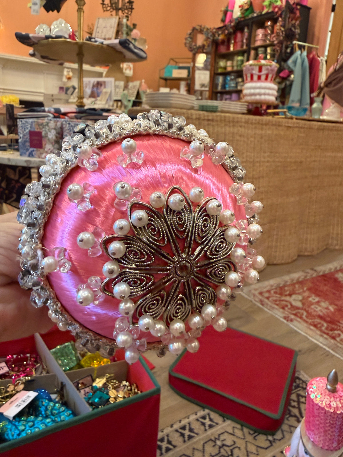 one-of-a-kind vintage pink satin Christmas ornament featuring sparkling rhinestones, faux pearls, silver trim, and intricate handmade details.