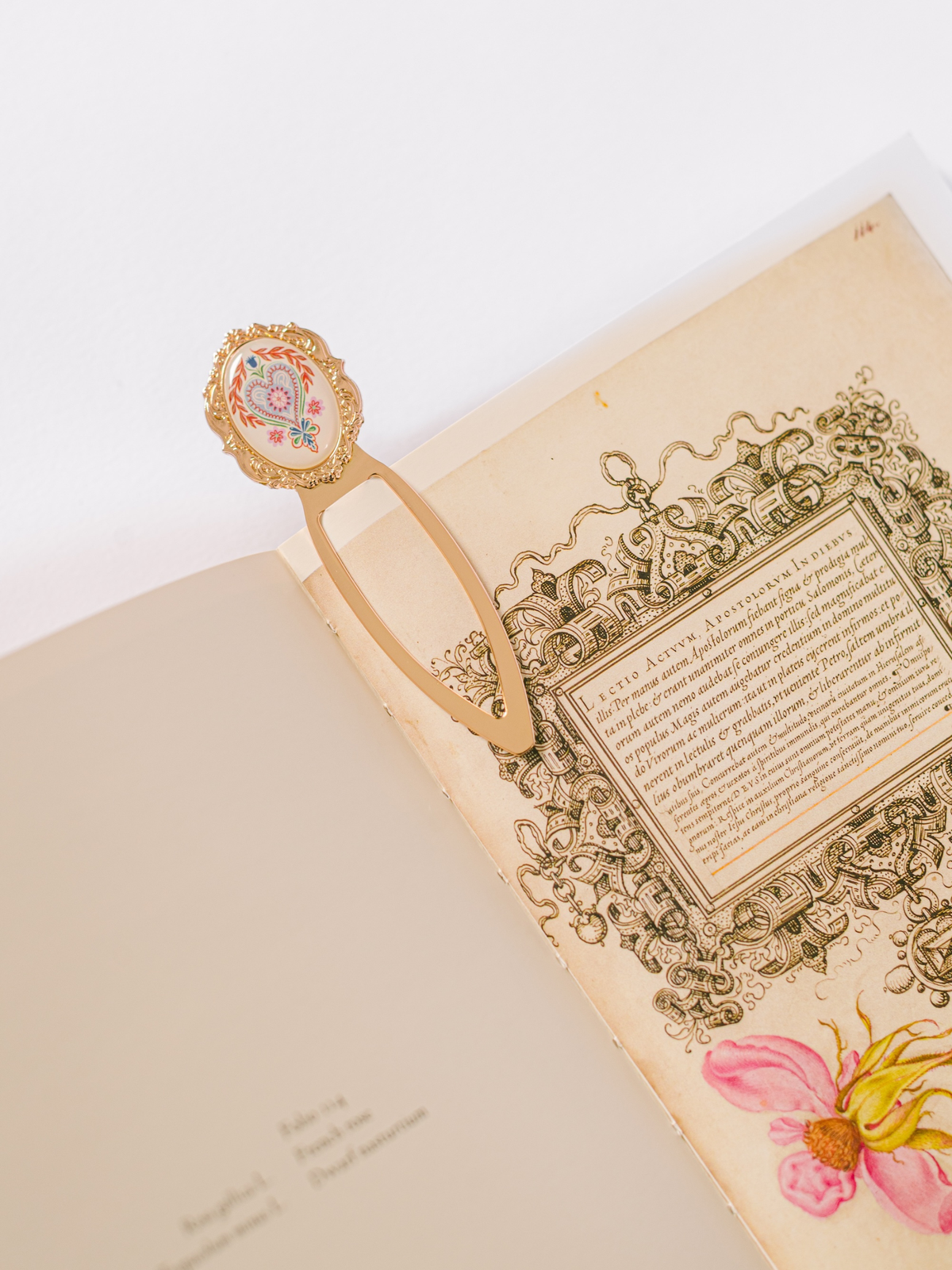 Good Juju Ink Folk Heart Metal Clip Bookmark with colorful heart illustration and gold-tone finish in patterned gift packaging
