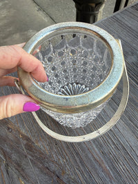 Hand holding a decorative metal mesh over a textured surface