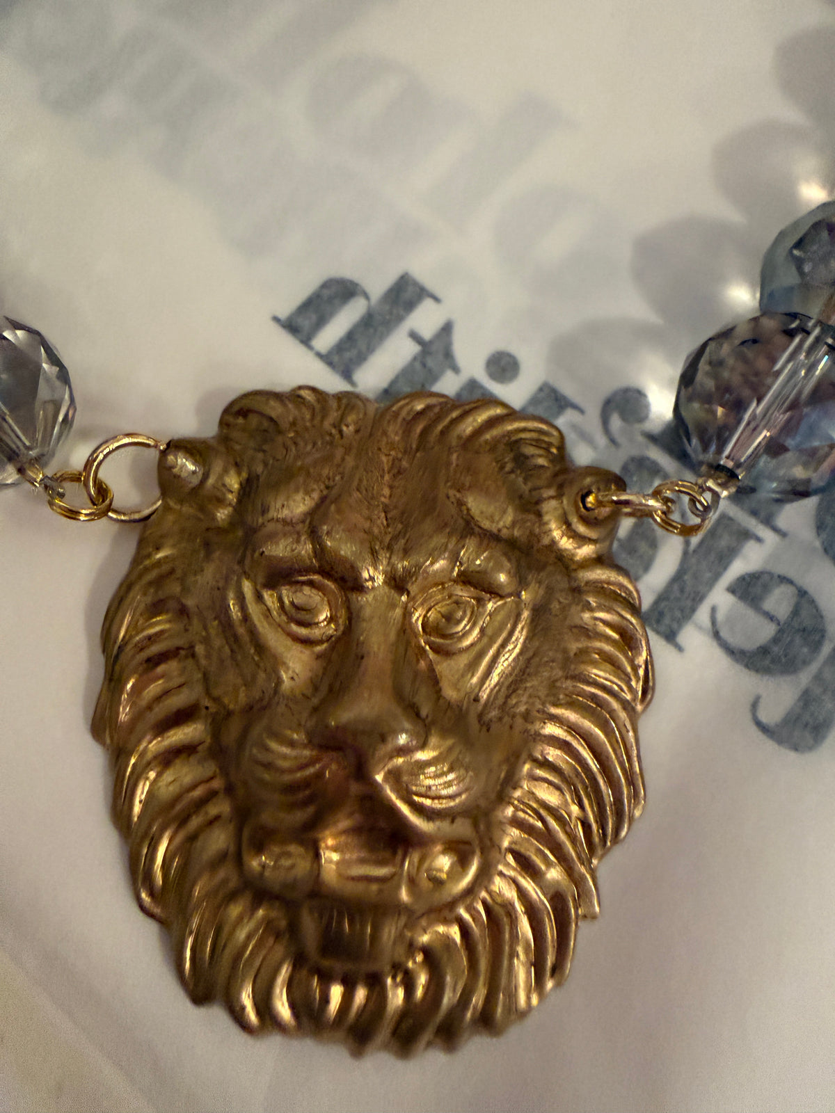 Made in the Deep South necklace with faceted multicolored glass beads and a gold-tone lion head pendant.