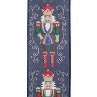 Reliant Ribbon navy blue Nutcracker Filigree Elegance Christmas ribbon featuring colorful traditional nutcrackers surrounded by ornate gold scrollwork, 2.5-inch wired edge.