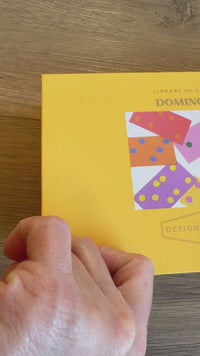 boxed dominoes game, tabletop dominoes set, stylish dominoes gift, classic domino game, colorful wooden dominoes, gold foil domino set, family game night essentials, design-focused dominoes, giftable board games, modern domino set