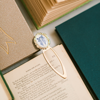 Decorative bookmark with a blue bow on an open book