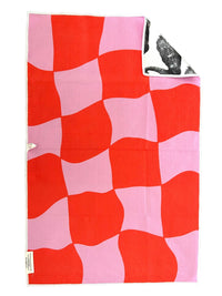 Red and pink checkered towel with a white tag on a white background