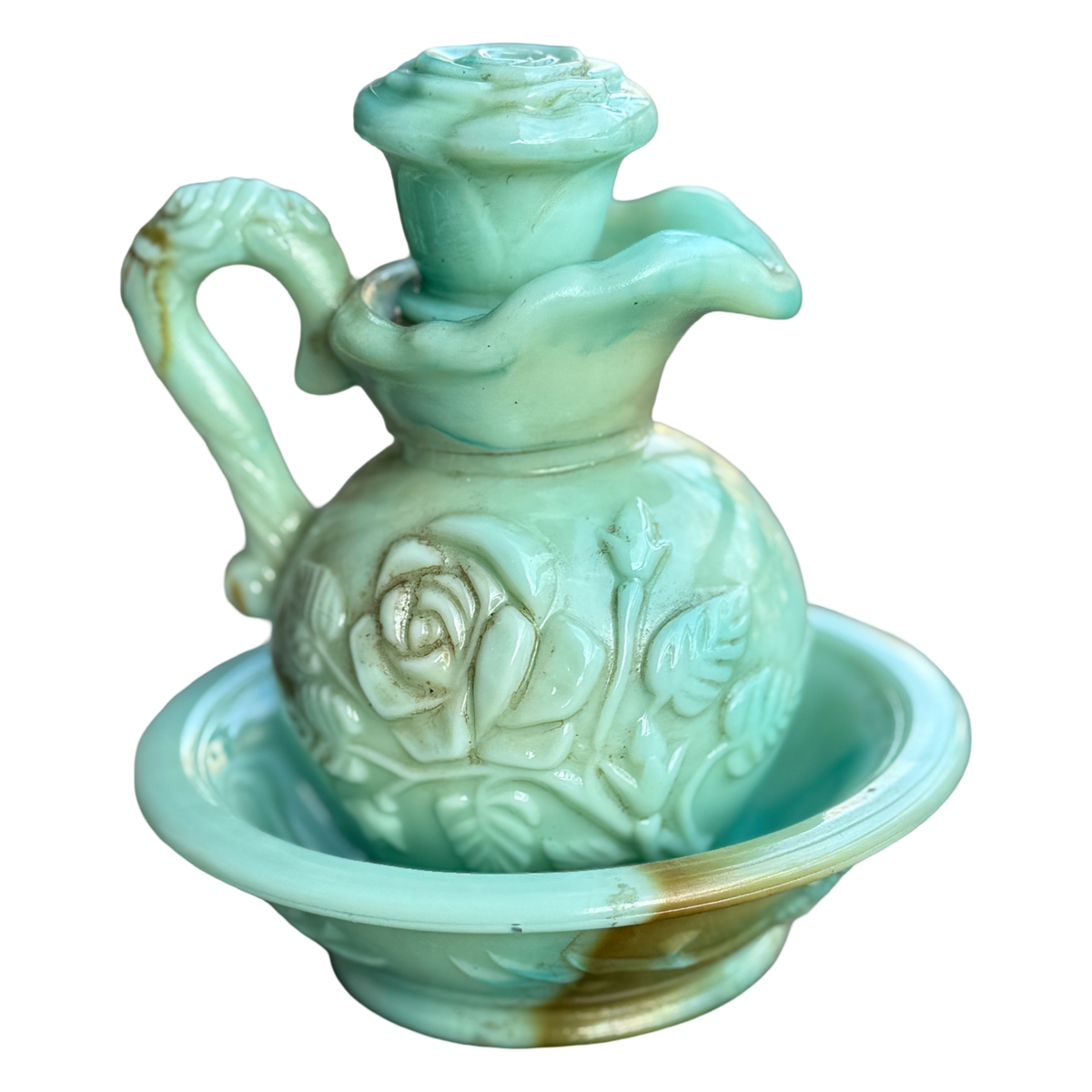 Decorative ceramic oil lamp with floral designs on a white background