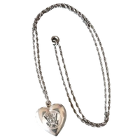 Silver heart-shaped pendant necklace on a white background