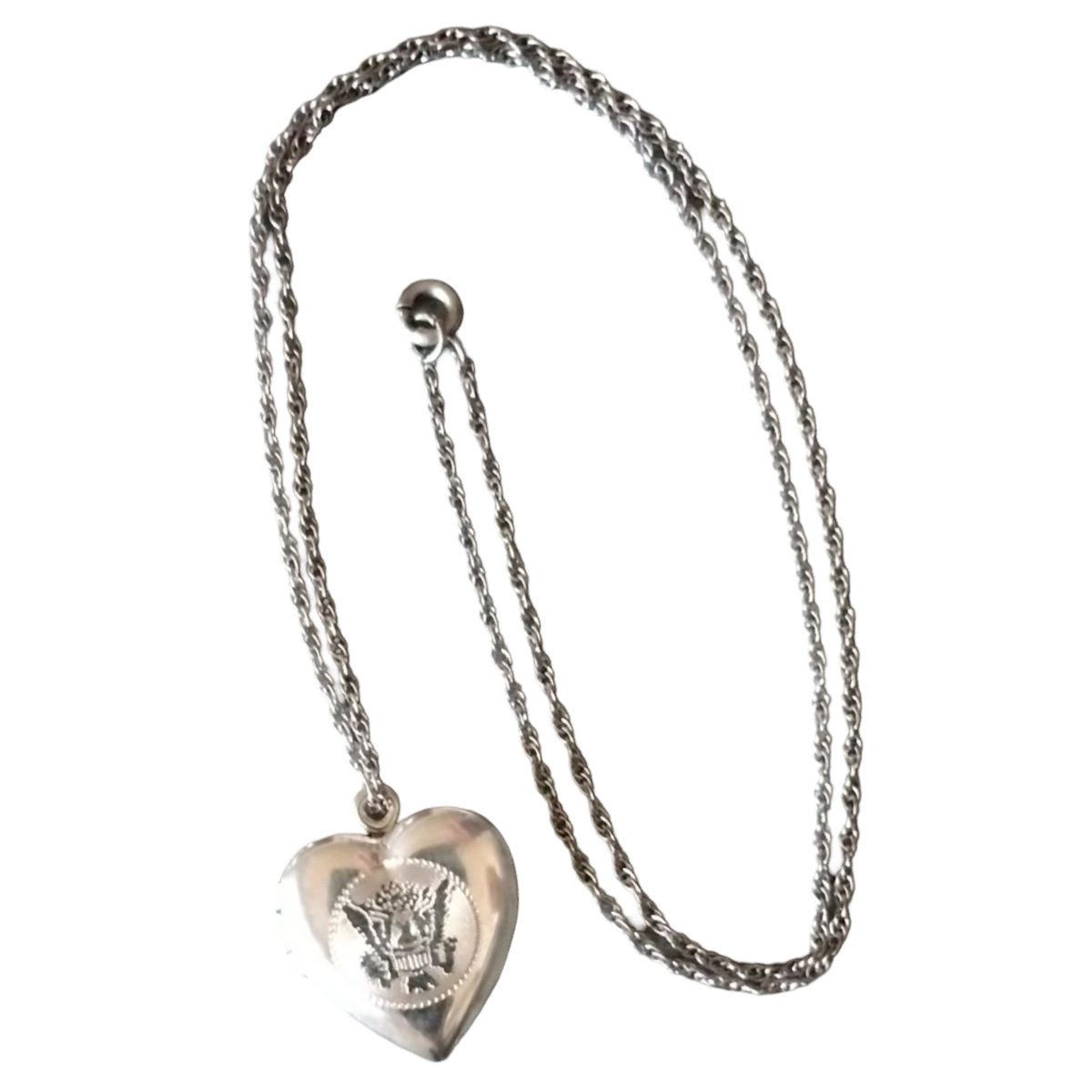 Silver heart-shaped pendant necklace on a white background