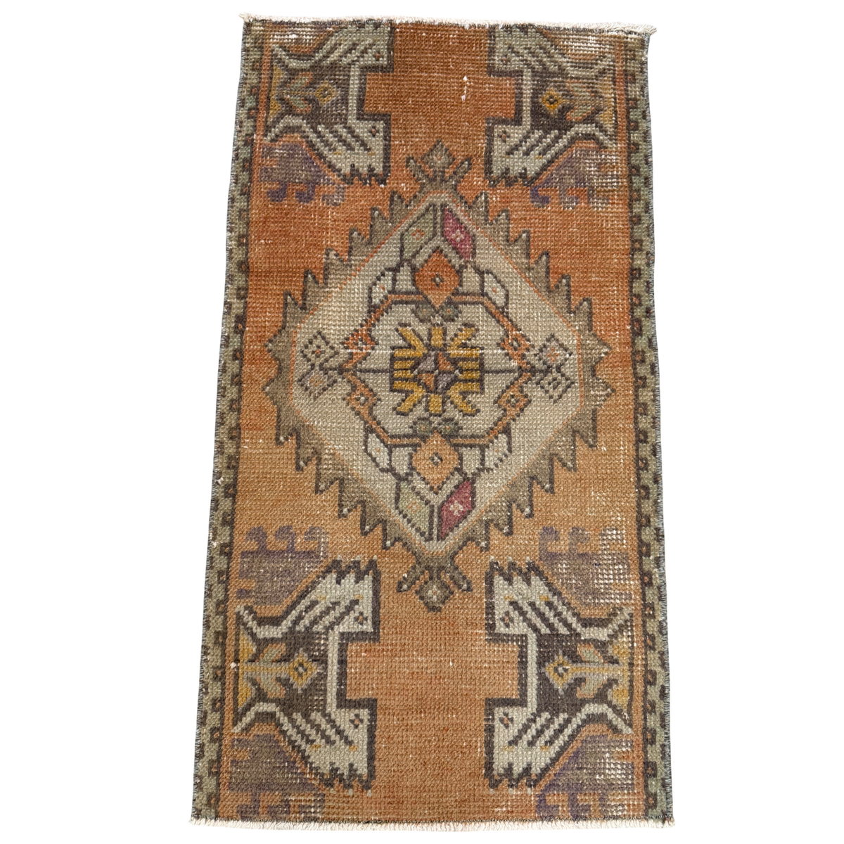 Vintage-style rug with geometric pattern on a plain background